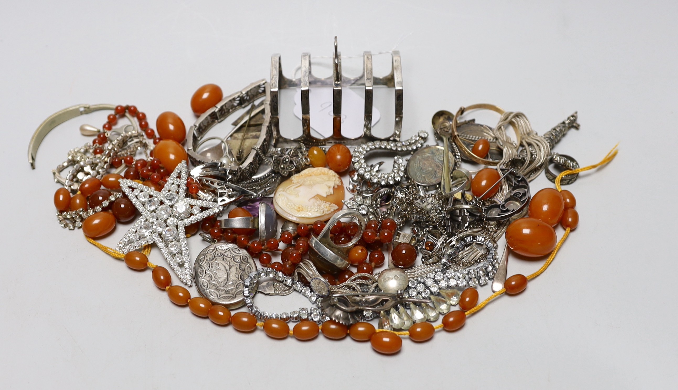 Mixed costume jewellery including a silver, marcasite and moonstone set flower brooch, faux amber beads, etc. and a silver five bar toast rack.